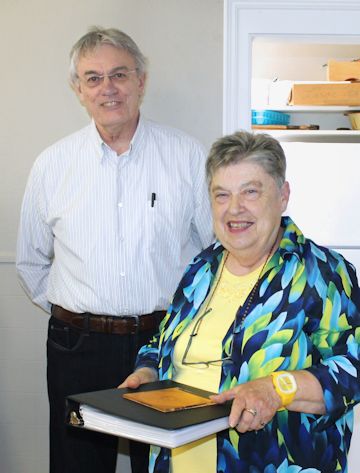Tim McGinnis (left) presents the duplicated church register of St. Luke`s Anglican Church to warden Elaine Emmerton 